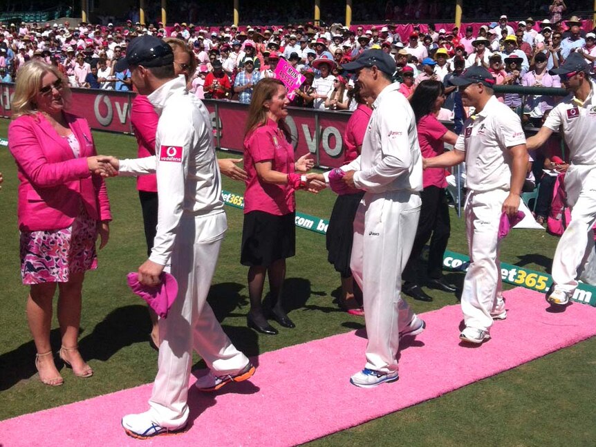 Day of pink ... the Australian Test team partakes in a pink carpet ceremony on Jane McGrath Day.