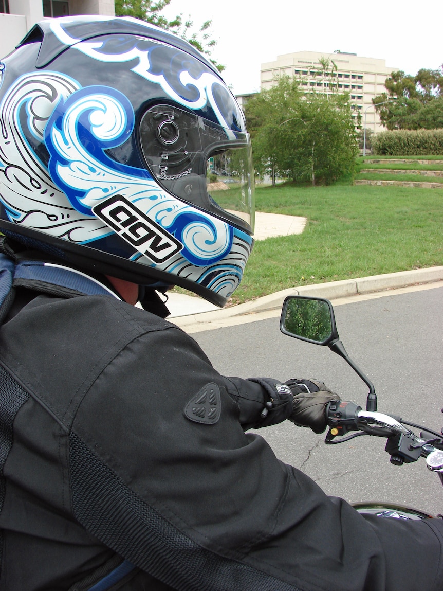 Close-up of motorcyclist wearing helmet - generic