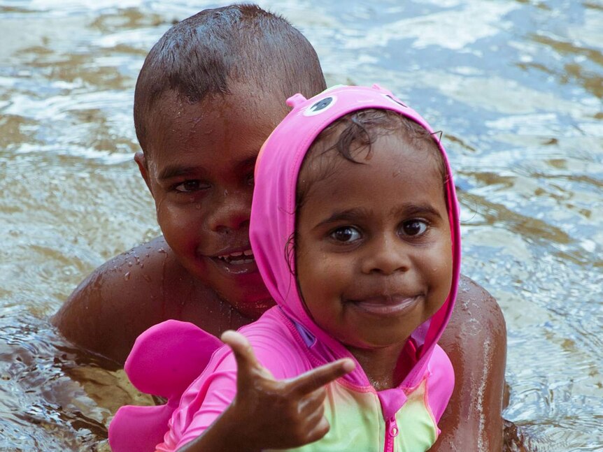 Junior's brother and sister, Tyrese and Tahan play in the water.