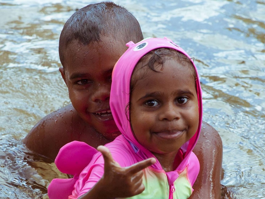 Junior's brother and sister, Tyrese and Tahan play in the water.