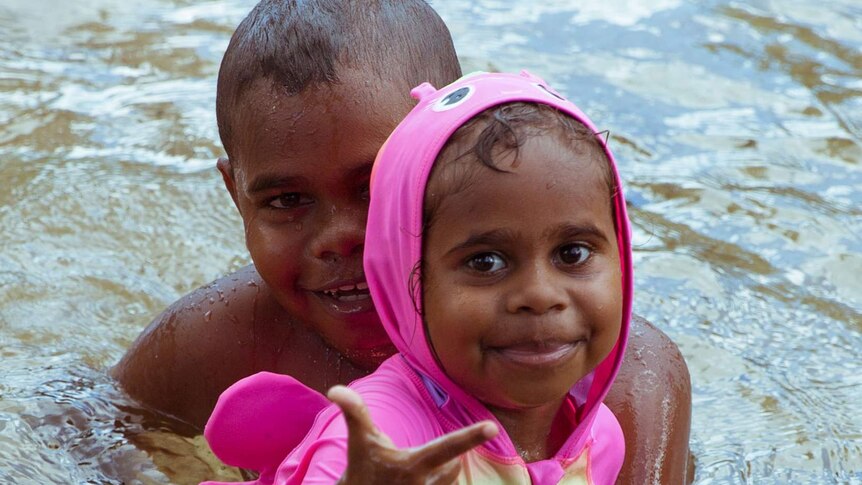 Junior's brother and sister, Tyrese and Tahan play in the water.