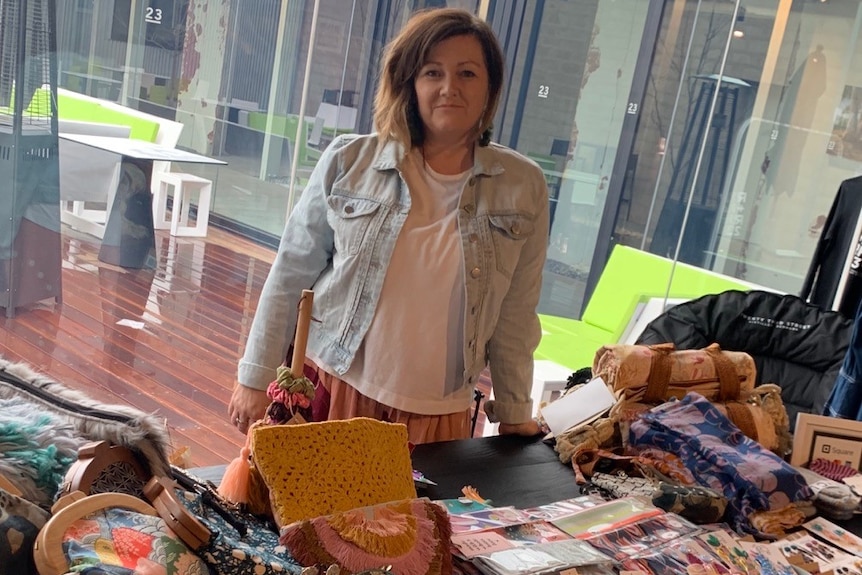 Cushla Baldock behind a market stall selling earrings and other items