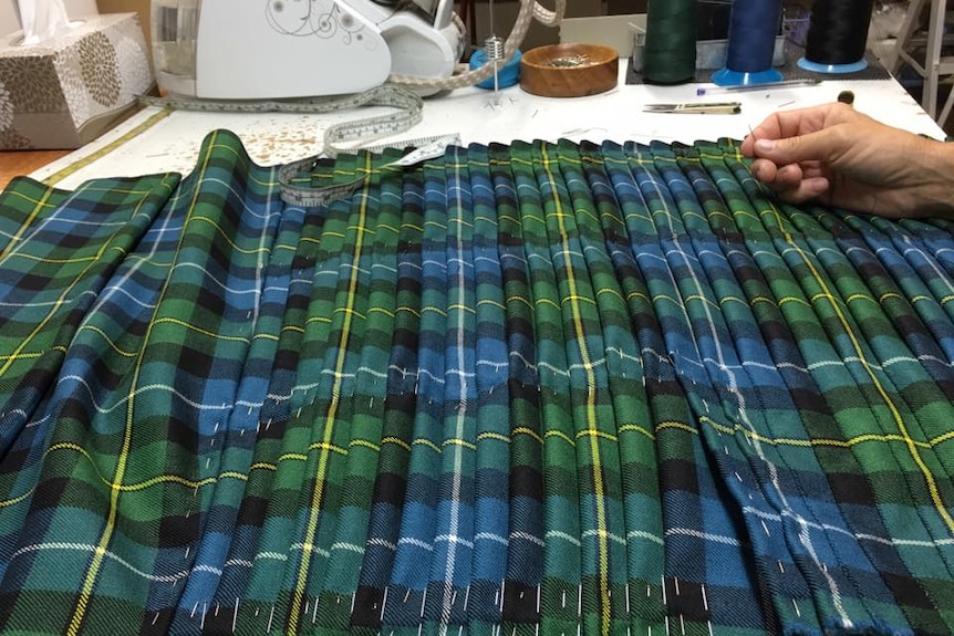 Karen Manger stitches each pleat by hand of every kilt she makes.