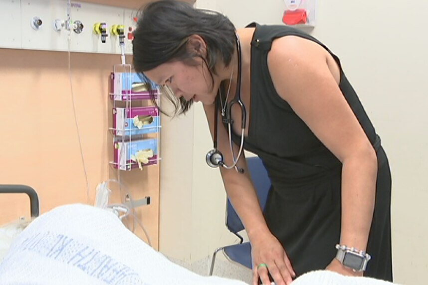 Nepean Hospital's acting head of ICU, Nhi Nguyen, talks to a patient