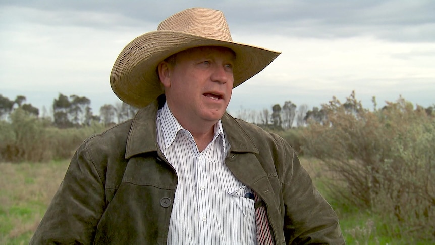 Photo of a man in a akubra hat talking.