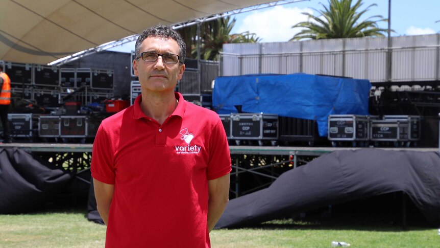 Phil Croot standing in front of the Carols by Candlelight stage.