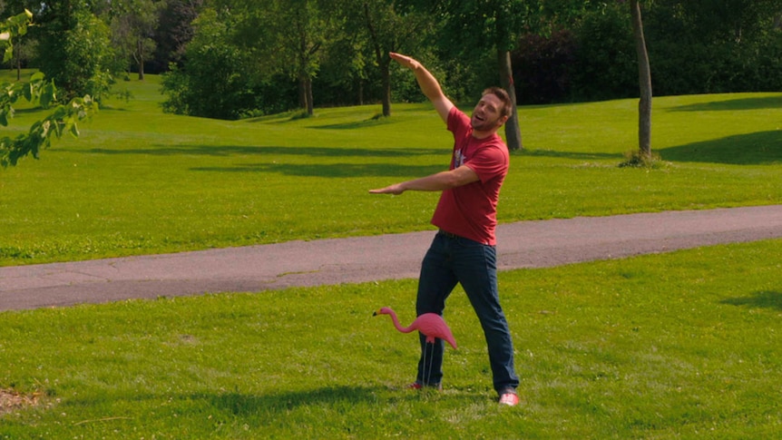 Man stands outside with arms outstretched to indicate something of big size