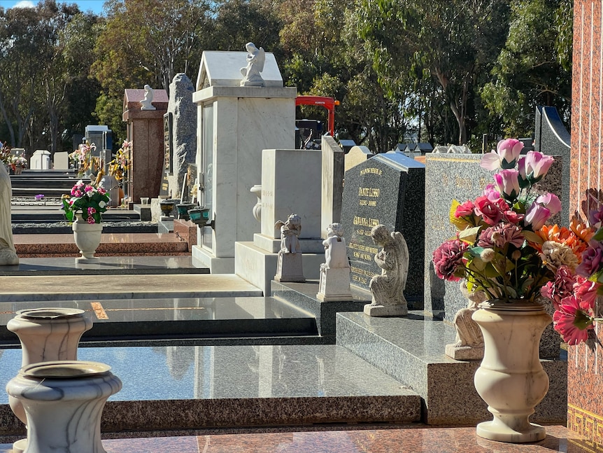 grave sites in a cemetery adorned with flowers