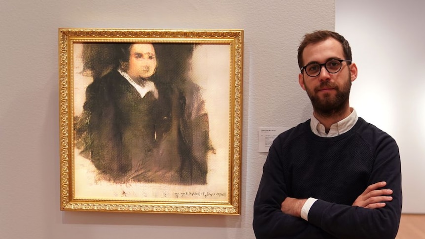 Co-founder of Obvious, Pierre Fautrel, poses next to Portrait of Edmond de Belamy painting.