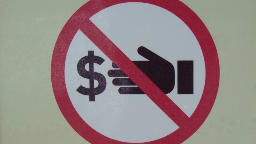 sign against corruption: a dollar sign and a hand - crossed out