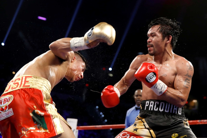 Manny Pacquiao (R) hits WBO welterweight champion Jessie Vargas in their 2016 fight in Las Vegas.