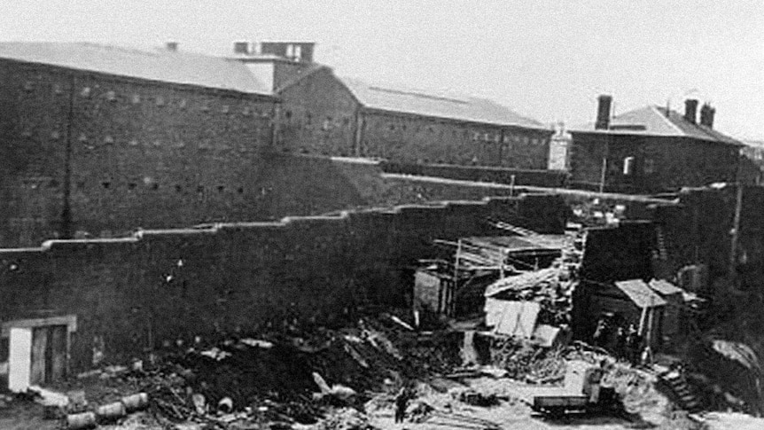 A black and white image of the Old Melbourne Gaol being dismantled in 1929.