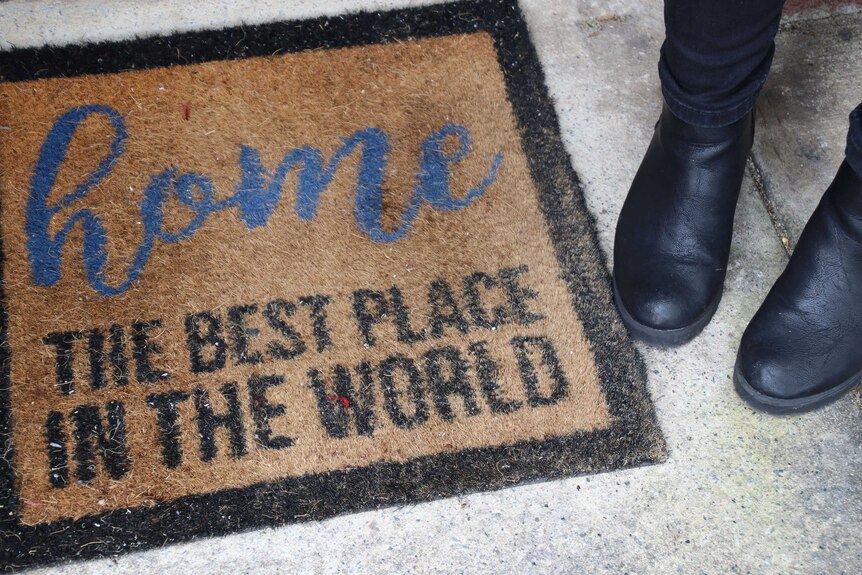 A doormat that reads 'home: the best place in the world'