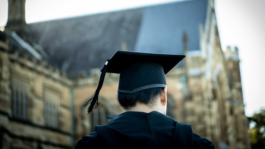 A man in graduation outfit.