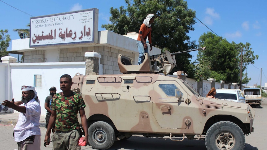 Yemeni pro-government fighters gather outside an elderly care home in Yemen's main southern city of Aden