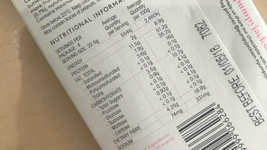 A food label on a block of chocolate displays the different types of sugar in the product.