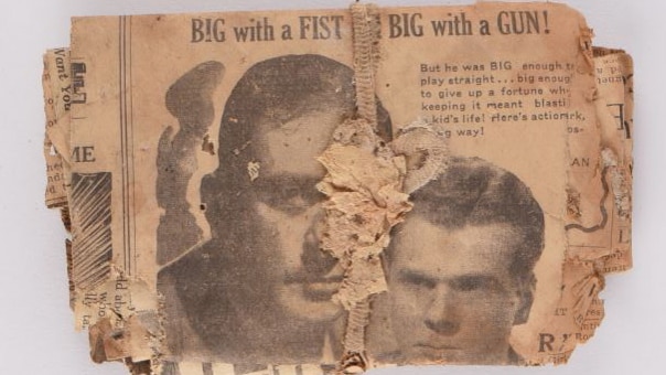 An old newspaper clipping tied into a bundle