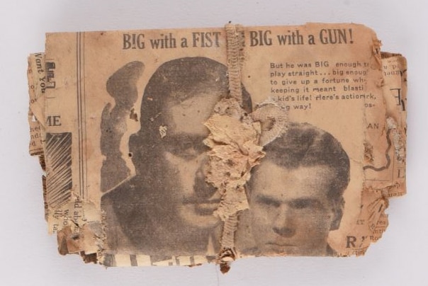 An old newspaper clipping tied into a bundle