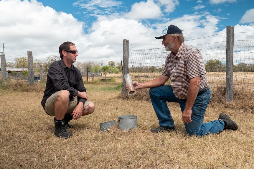 Gerard Walsh and BoM technician Liam Carrol check the rain gauge at the Walsh farm near Warwick, February 2021.