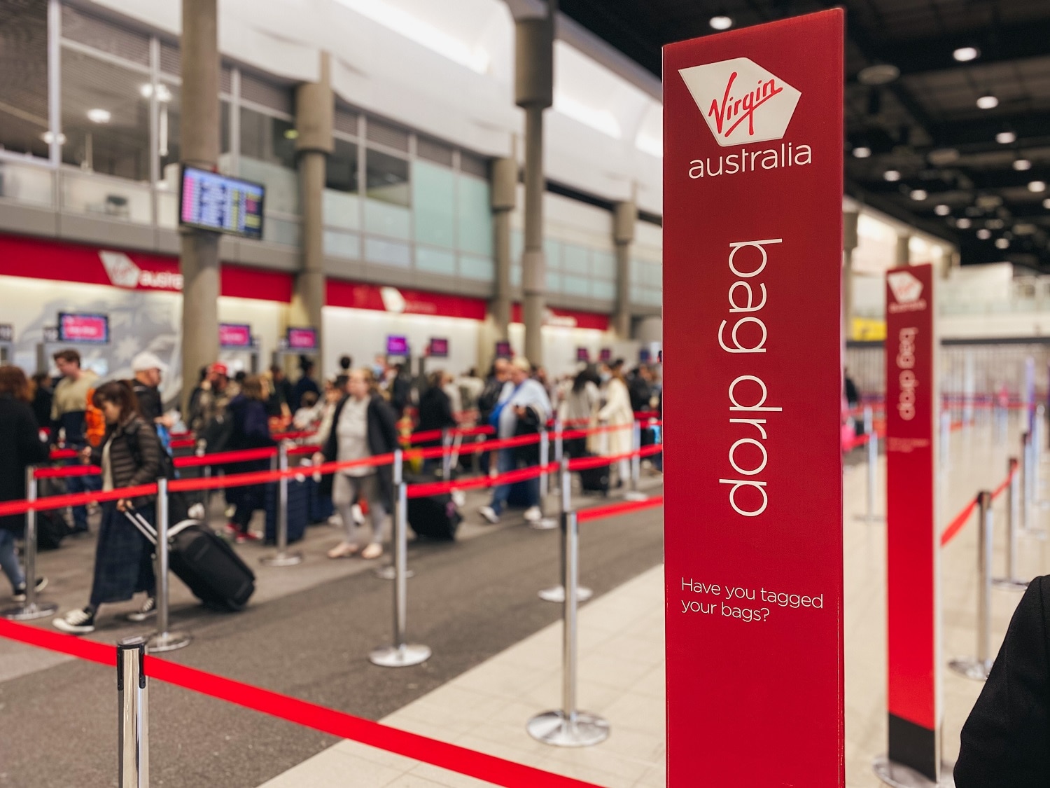 Line of people in queue at Virgin Australia check-in at Brisbane Airport