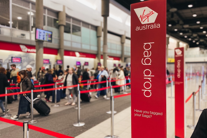 Line of people in queue at Virgin Australia check-in at Brisbane Airport