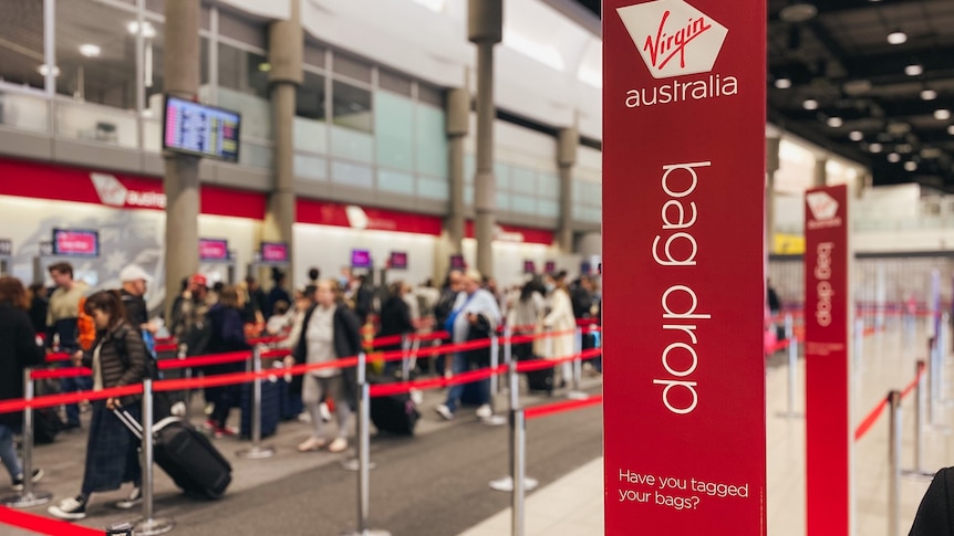 Line of people in queue at Virgin Australia check-in at Brisbane Airport