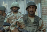 Pakistani paramilitary soldiers patrol a street of Karachi.