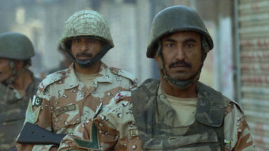 Pakistani paramilitary soldiers patrol a street of Karachi.