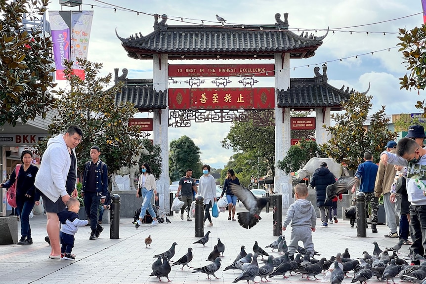 People walk down a street.