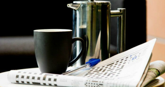 A crossword puzzle and coffee cup.