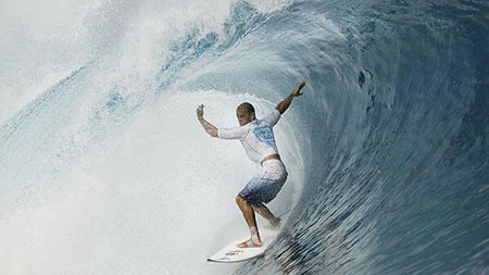 Kelly Slater rides a wave at a competition in Tahiti.