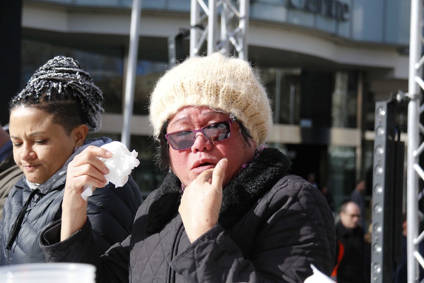 A woman turns red after eating a chilli.