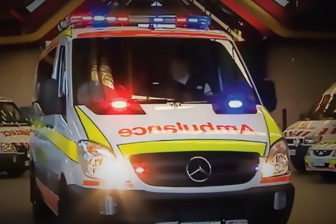 Tasmanian ambulance leaves a depot.