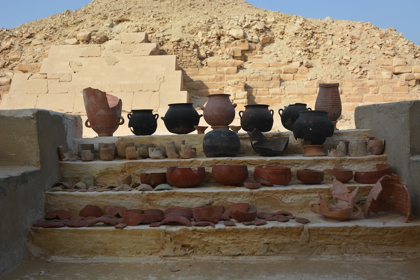 Ceramic pots in front of a pyramid