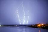 Lightning strikes across a purple sky south of Perth.