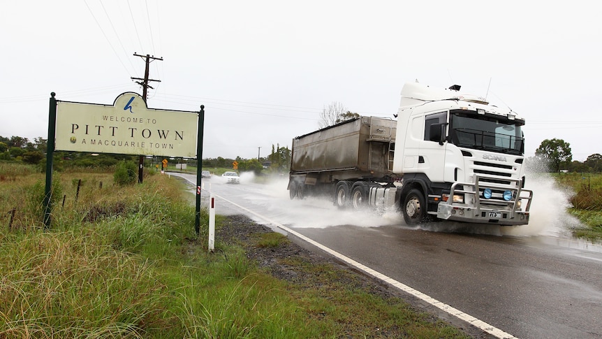 A truck drives through flood waters in Pitt Town on March 2, 2012 near Richmond, Australia.