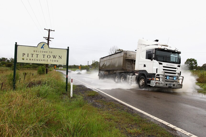 A truck drives through flood waters in Pitt Town on March 2, 2012 near Richmond, Australia.
