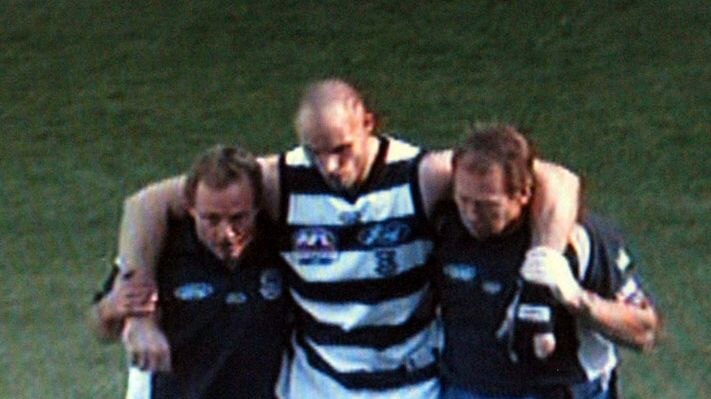 Geelong captain Tom Harley is helped from the field after a clash