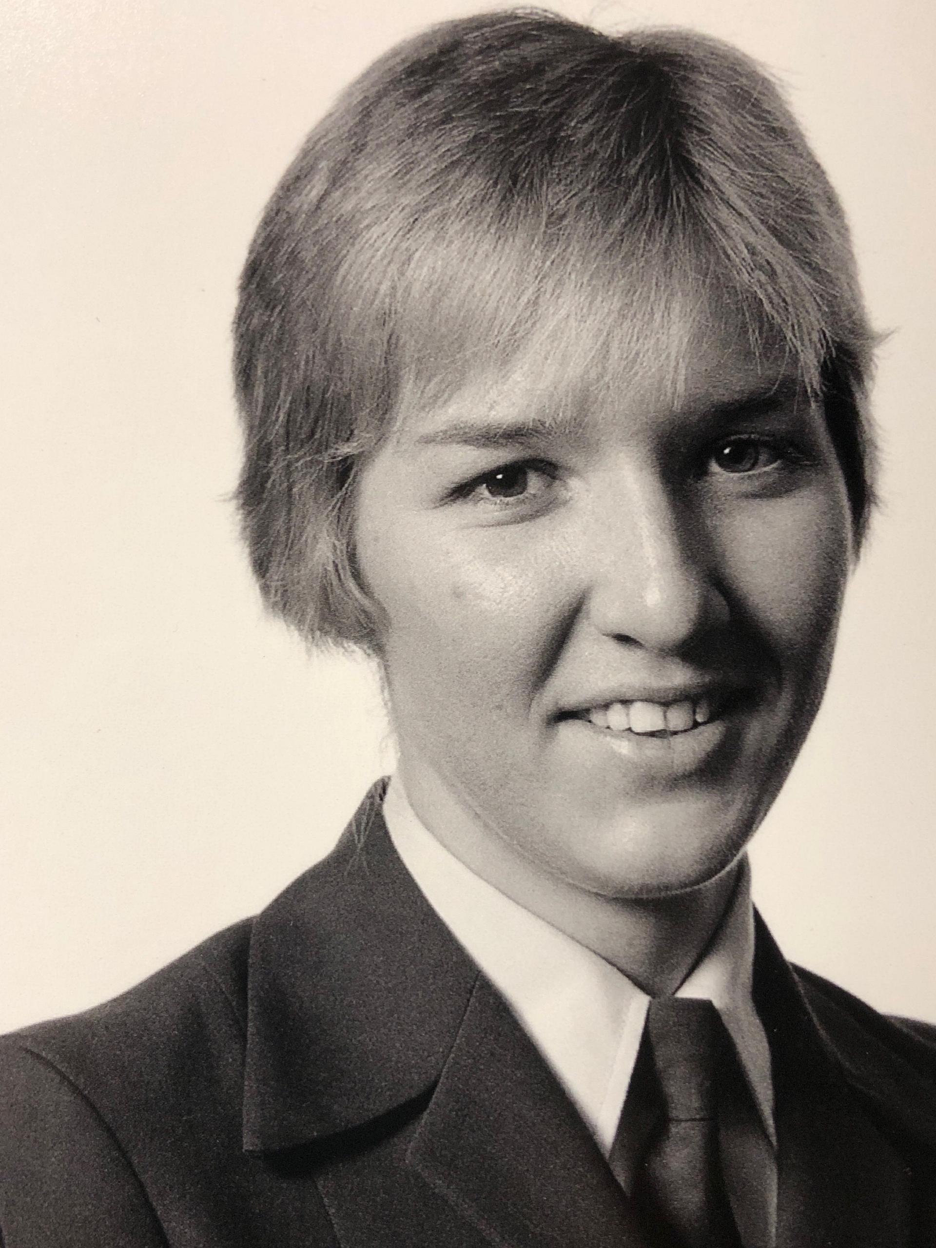 A sepia portrait of a young Katarina Carroll in a school uniform.