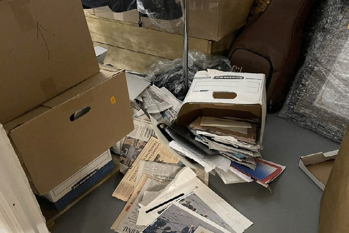 Documents spilled onto the floor of a storeroom.