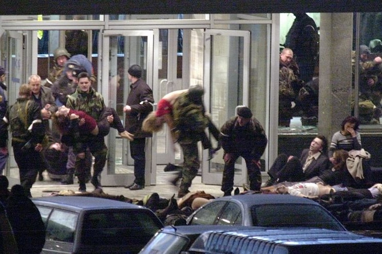 Special forces soldiers carry out hostages during the storming of a theatre building