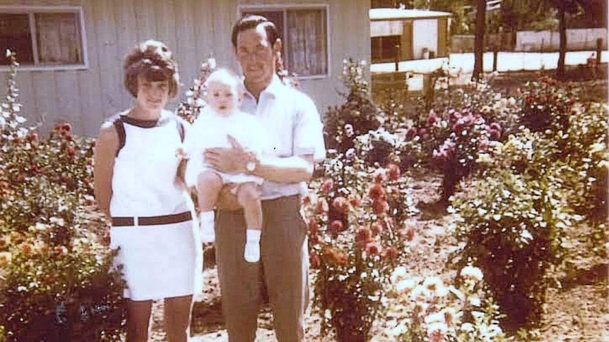 Colleen and Geoffrey Adams in a garden with their eldest daughter.