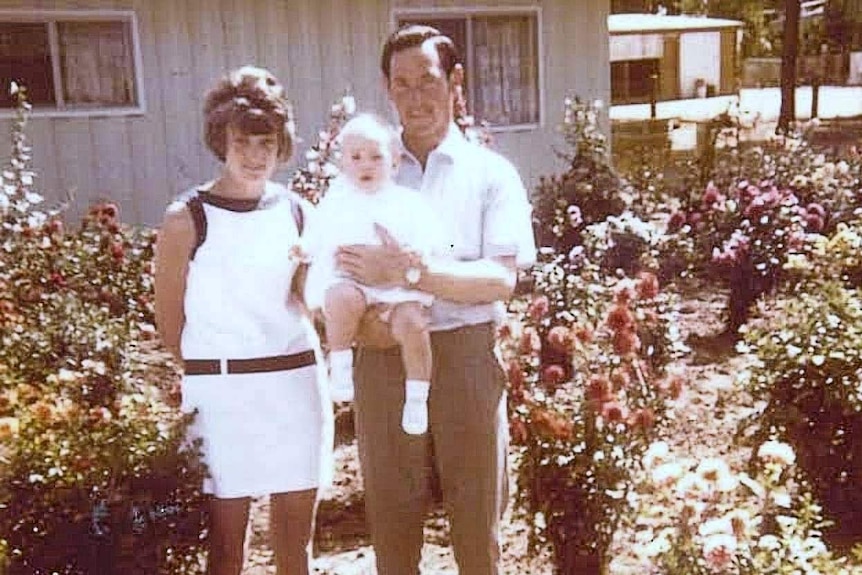 Colleen and Geoffrey Adams in a garden with their eldest daughter.