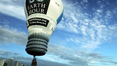 An Earth Hour light-bulb-shaped hot air balloon takes flight over Sydney Harbour