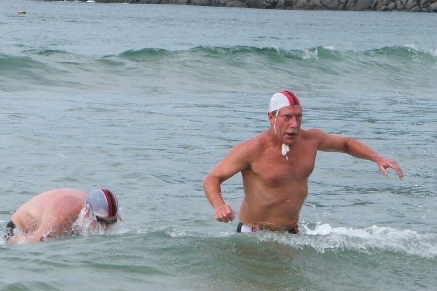 Don Marsh making his way back to the beach during a surf lifesaving competition