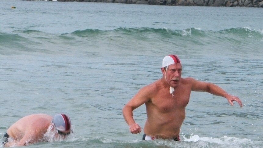 Don Marsh making his way back to the beach during a surf lifesaving competition