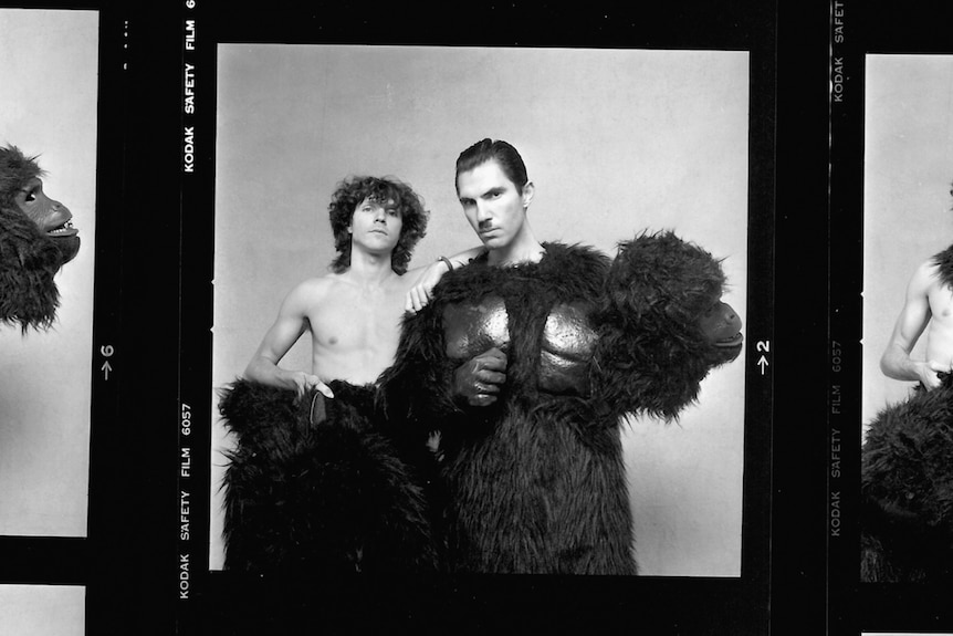 Russell Mael and Ron Mael pose wearing gorilla costumes, Ron with the head tucked under his arm in The Sparks Brothers