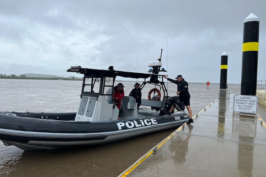 A swift water police boat with three police on board. 