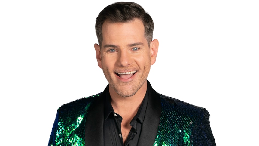 Man wearing a sparkly green jacket over a black shirt.