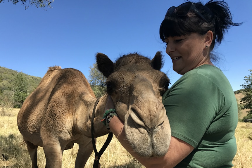 Melanie Fitzgibbon hugging a camel.